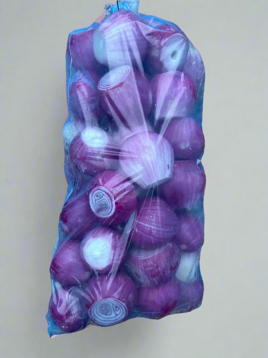 Packaged onions on a speckled surface